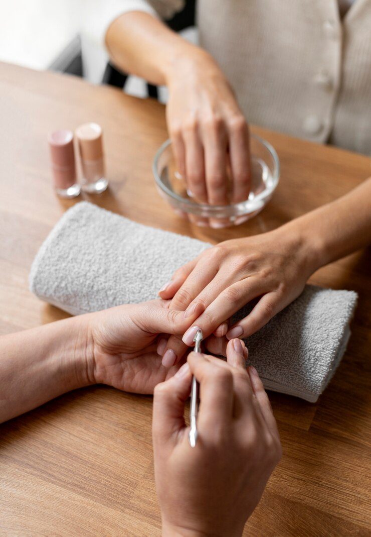 close-up-manicurist-holding-nail-tool_23-2149171317