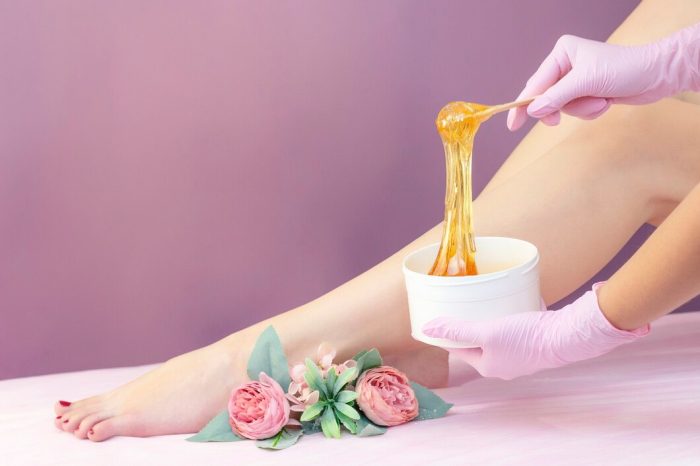 young-woman-having-hair-removal-procedure-leg-with-sugaring-paste-salon_170532-2576